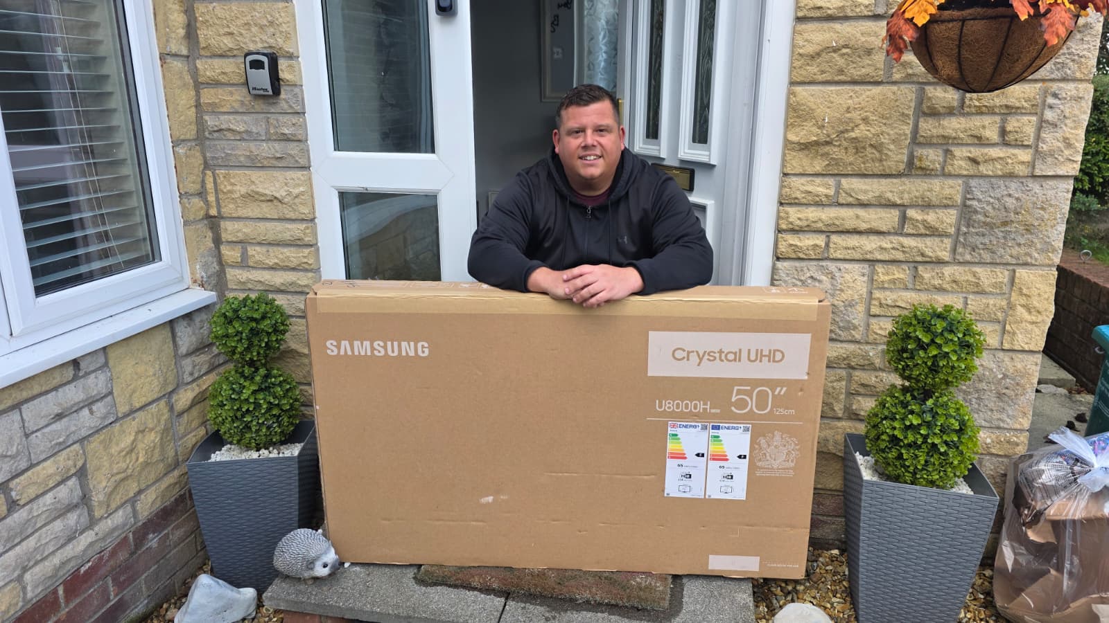 Matthew Hulse with their Samsung 50" 4K Smart TV prize from Coast Competitions