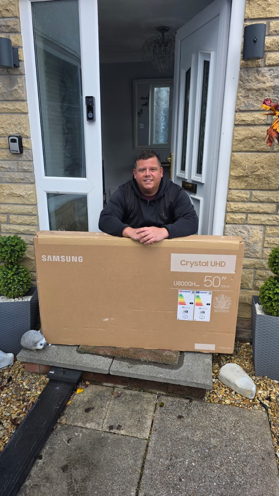 Matthew Hulse collecting their Samsung 50" 4K Smart TV